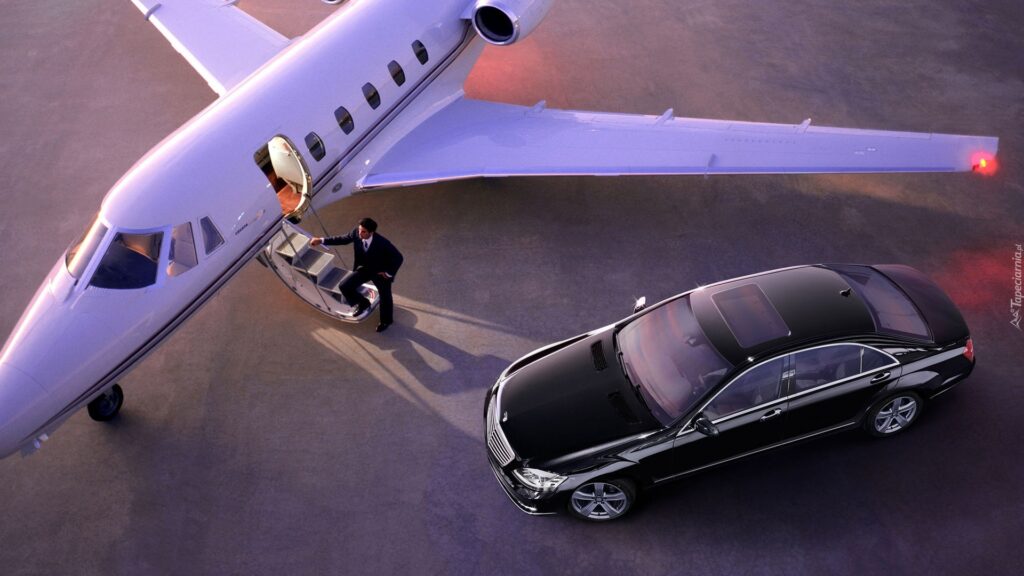 Black sedan parked beside a private jet on the ramp