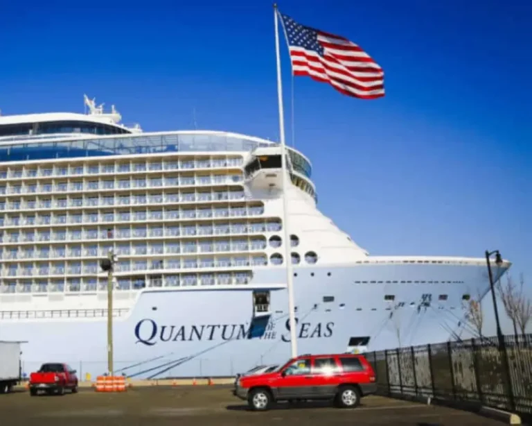 Cruise ship moored at a terminal under a blue sky