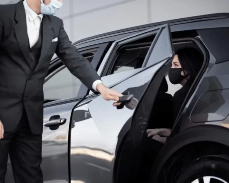 Chauffeur opening the rear door for a passenger