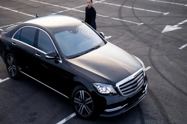 Black Mercedes S-Class parked in an open lot
