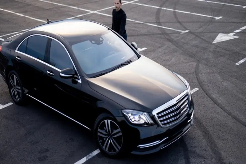 Black Mercedes S-Class parked in an open lot
