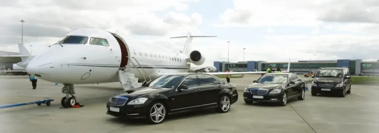 Black Mercedes sedans waiting beside a private jet
