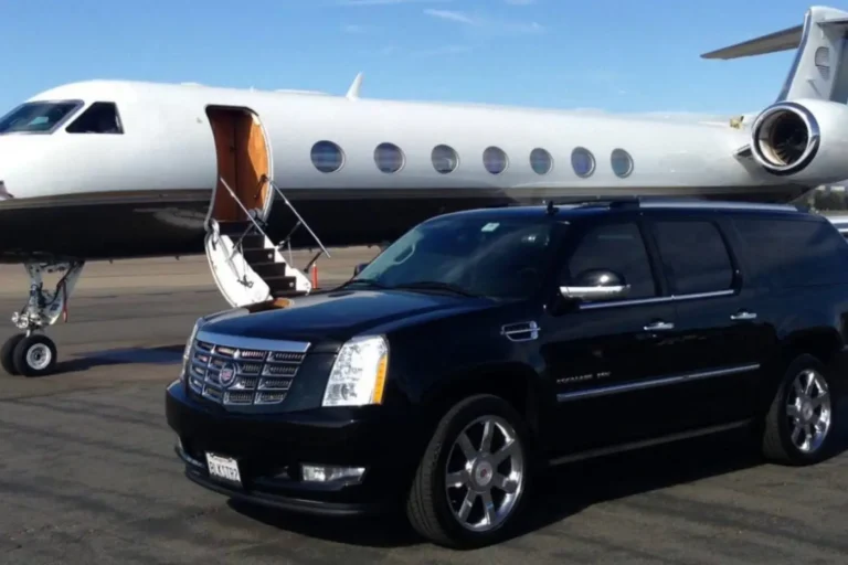 Black Cadillac Escalade parked beside a private jet