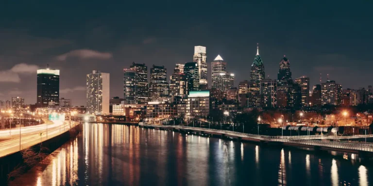 Philadelphia skyline lit up at night over the Schuylkill River