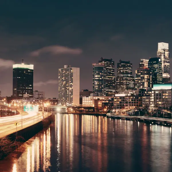 City skyline lit up at night over the river