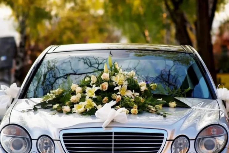 Wedding flowers on the bonnet of a silver sedan